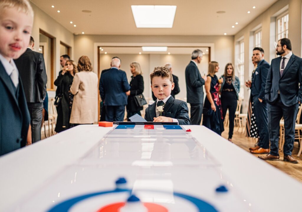 A boy playing a game at a wedding