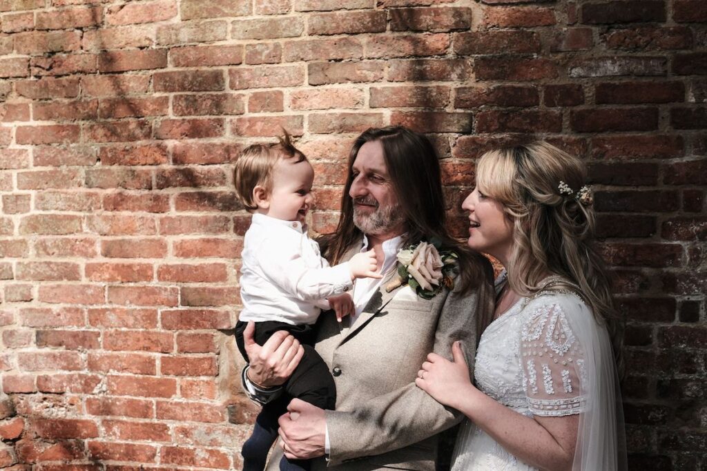 A wedding couple with their baby