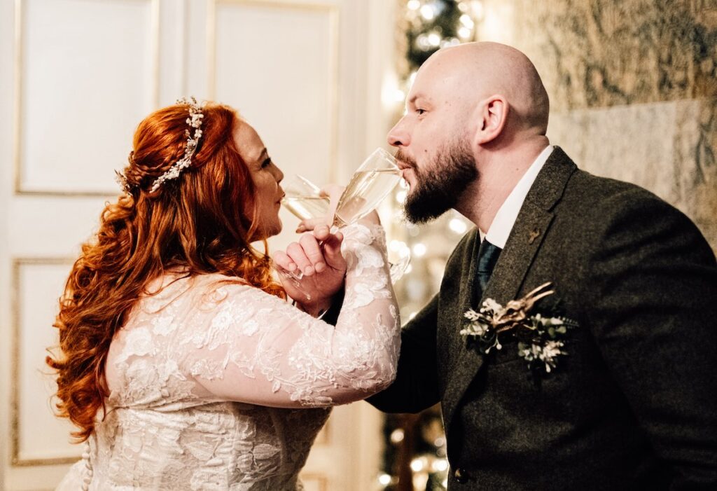 A newly-married couple celebrate with champagne