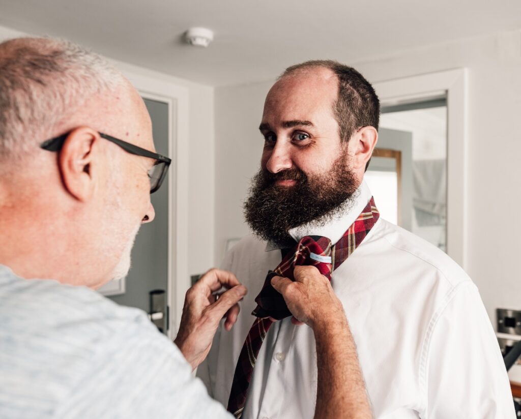A groom being helped by his Dad