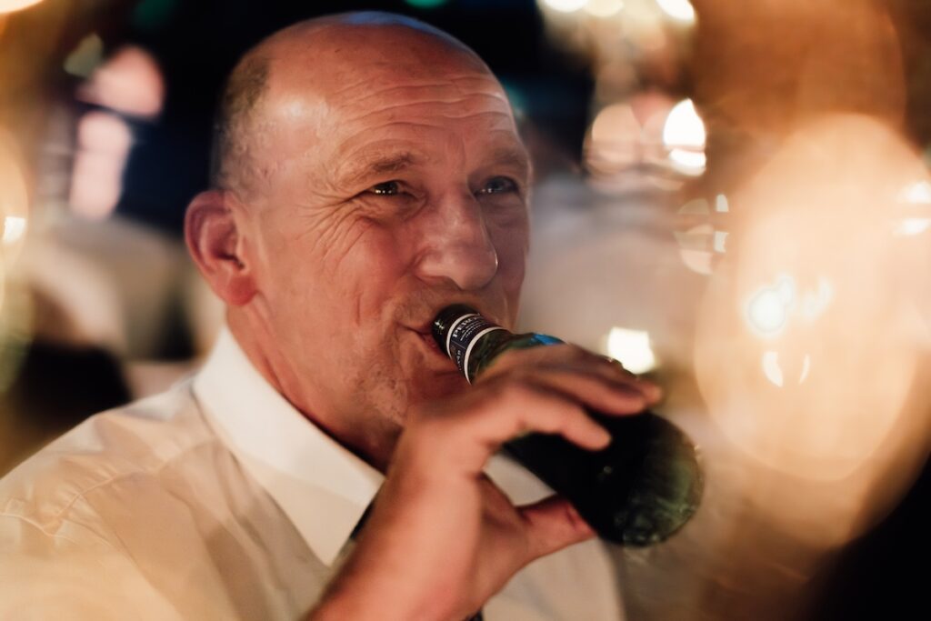 A wedding guest with a bottle