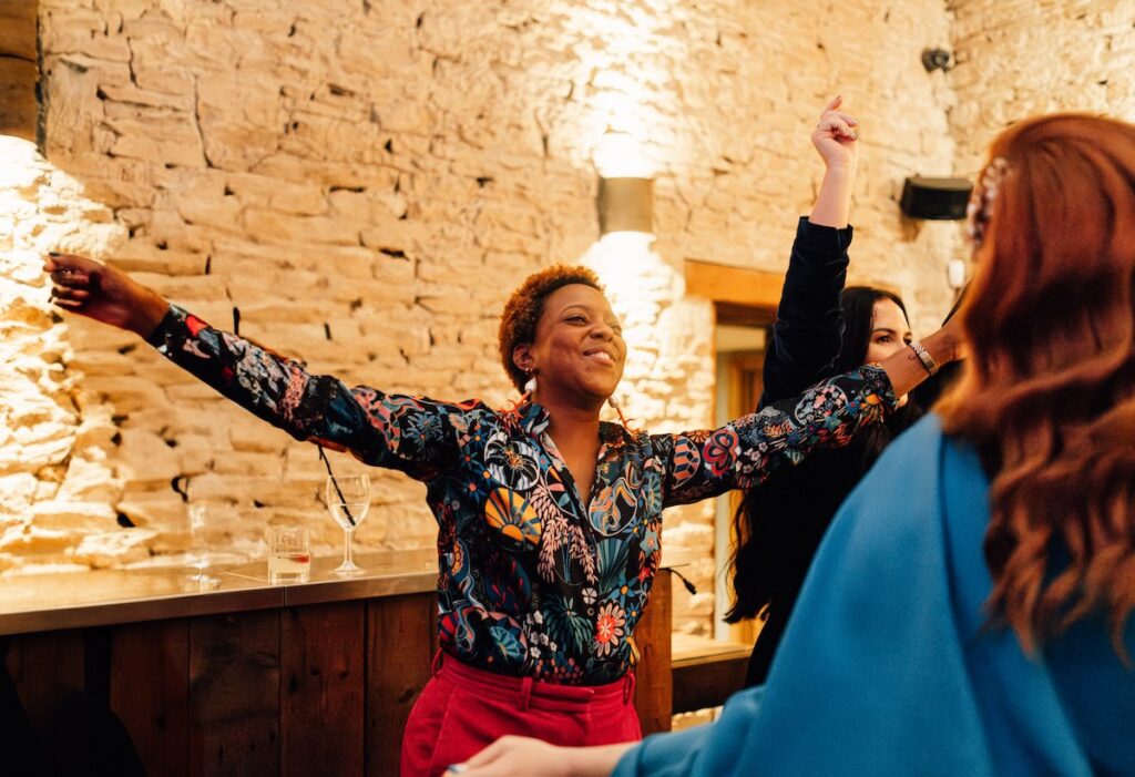 A happy wedding guest dancing