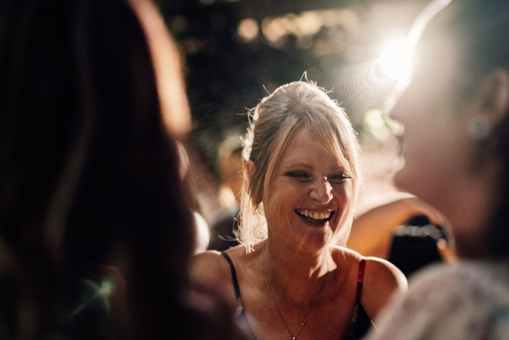 A wedding guest laughing