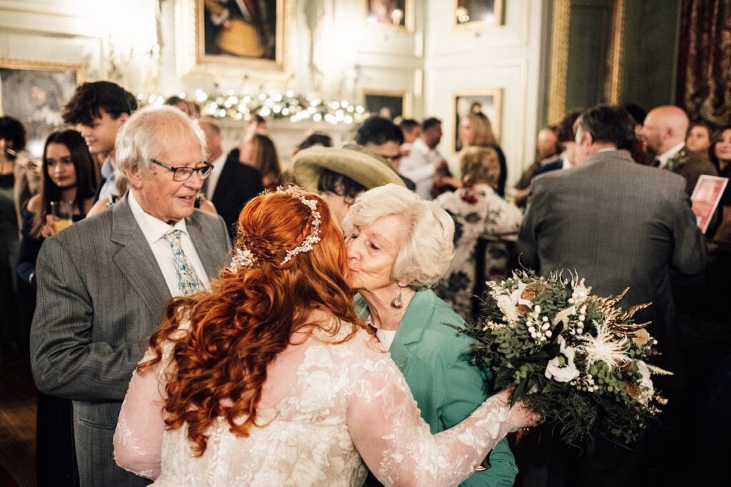 Wedding guest kissing the bride