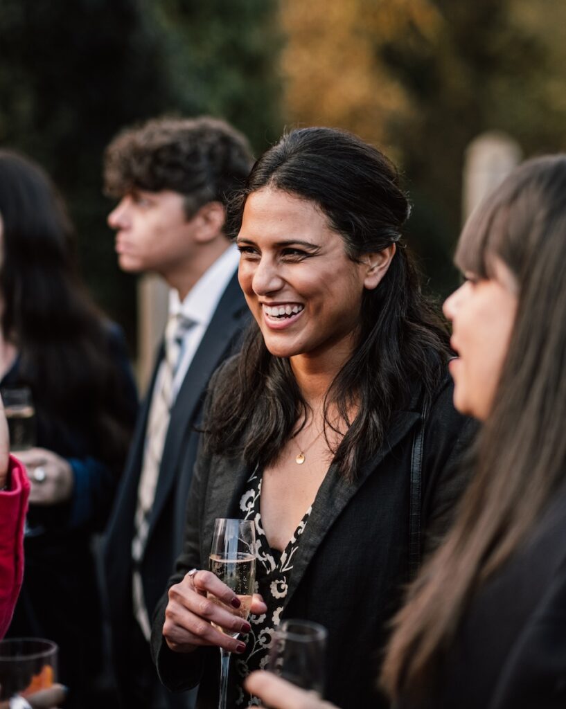 A wedding guest with a drink
