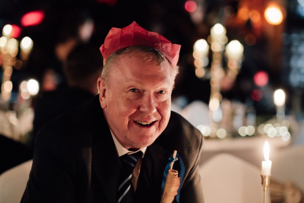 A wedding guest with a party hat 
