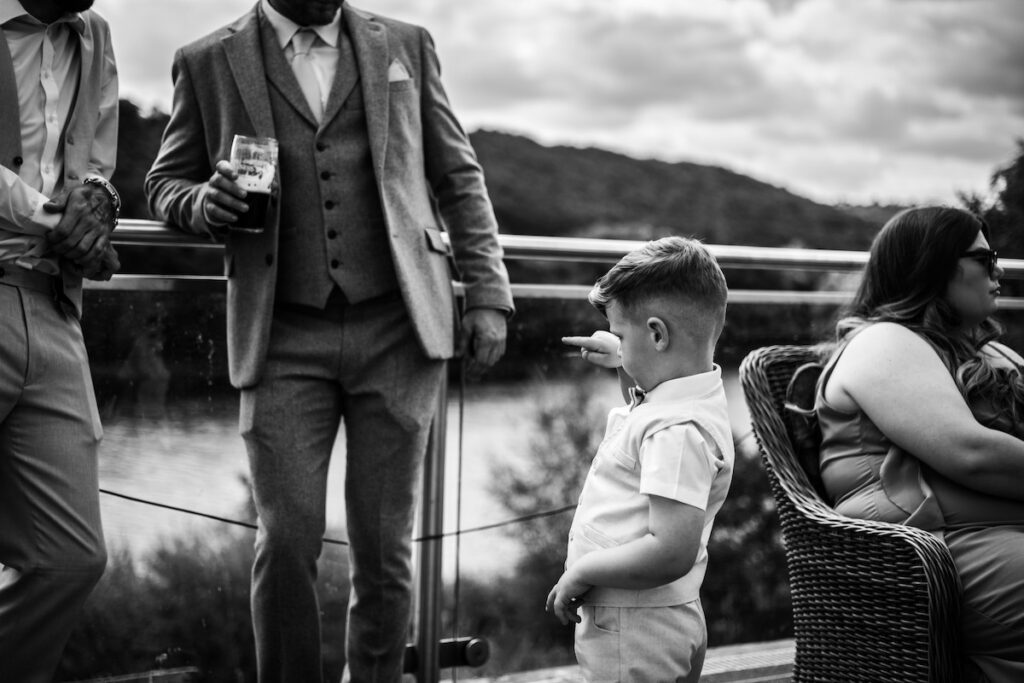 A black and white image of a young wedding guest