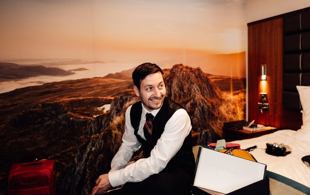 A smiling groomsman
