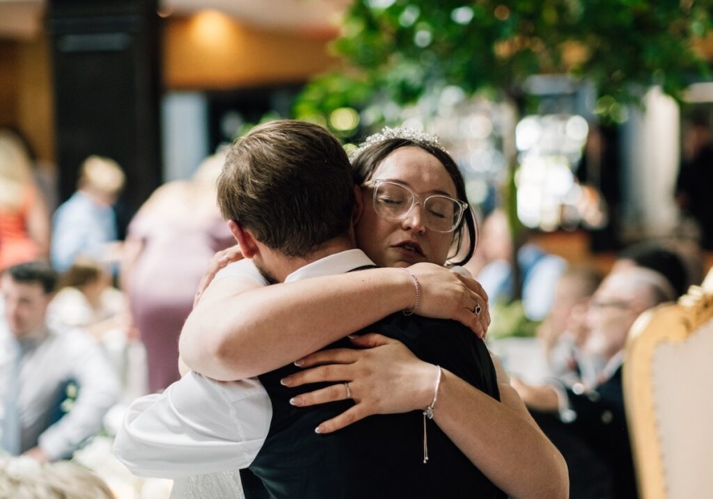A guest hugs the bride